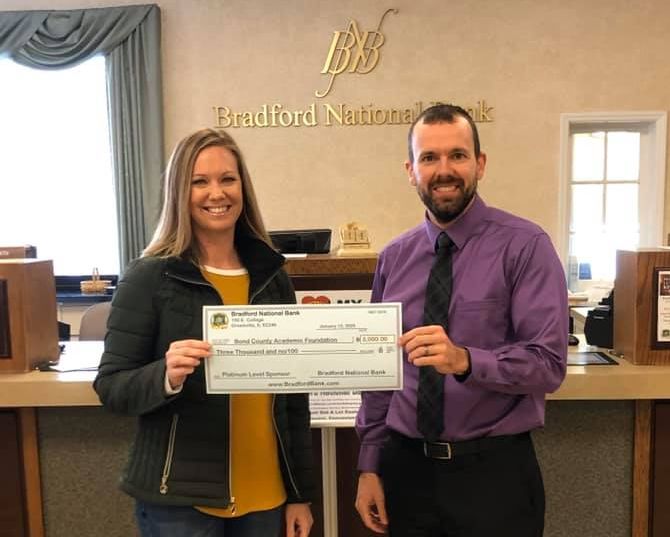 President Mike Ennen presented Bond County Academic Foundation Gala Chair Rachel Wayman with Bradford National Bank's Double Platinum Sponsorship check for 2020's gala.