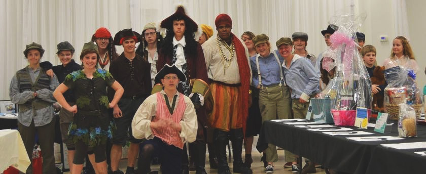 a dozen high school students dressed in pirate costume and late 1800s costume